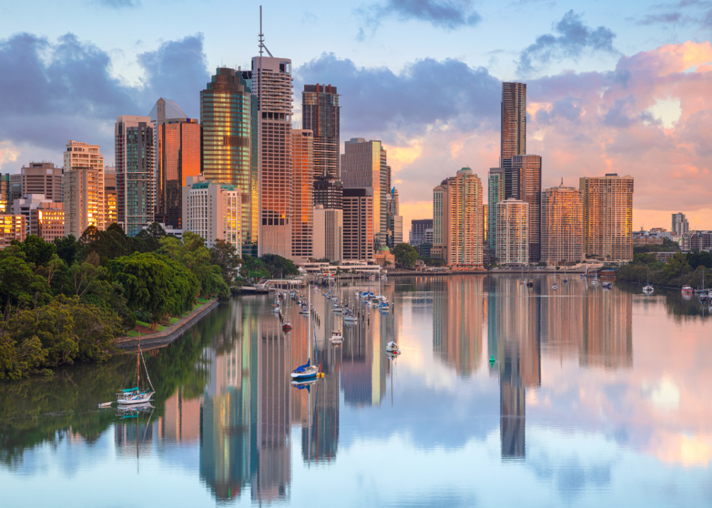 Talll, glass skyscrapers reflected in a body of water. 